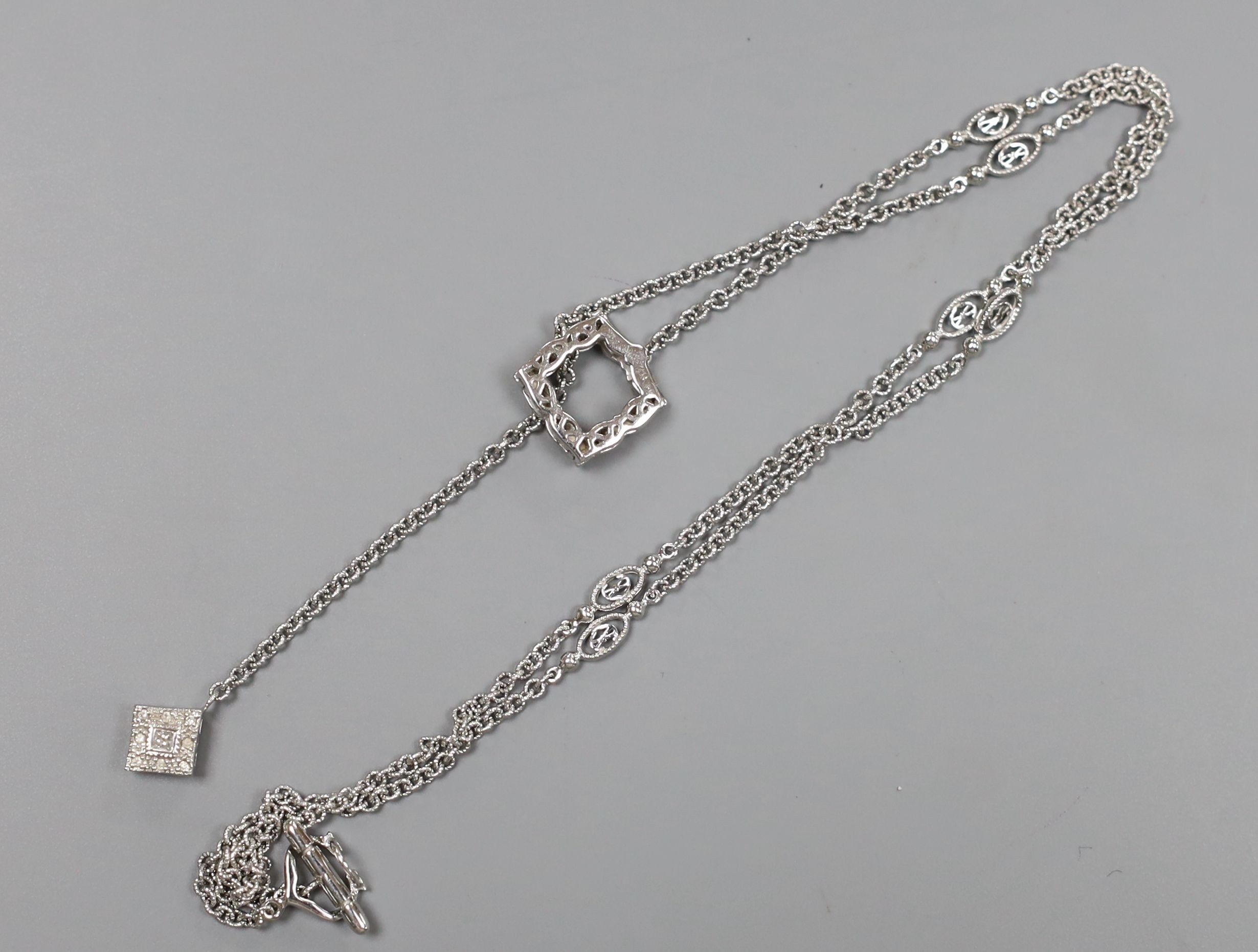 A modern 750 white metal and diamond cluster set drop necklace, 54cm, gross weight 10 grams.